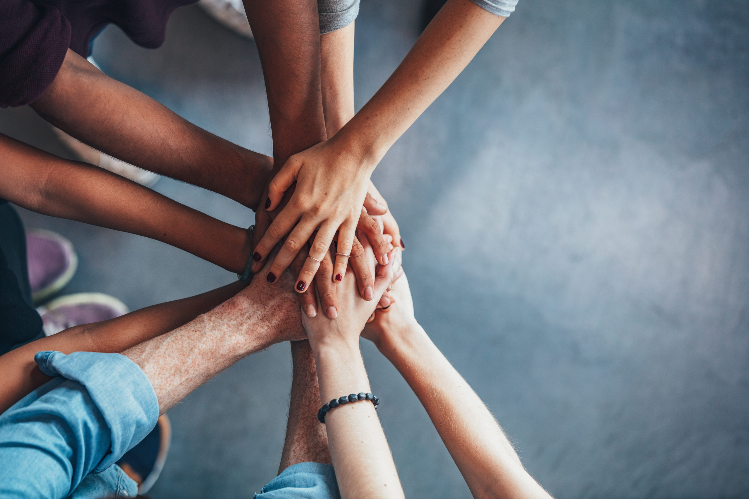 Stack of hands showing unity and teamwork.